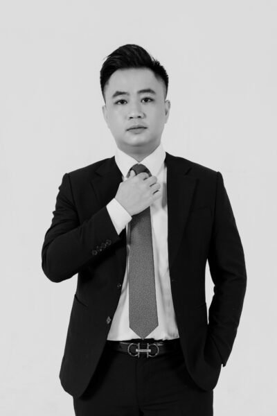 Professional studio portrait of a confident businessman in a suit and tie.