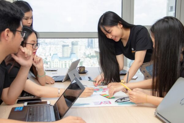 Group of colleagues engaged in a creative brainstorming session at an urban office space.
