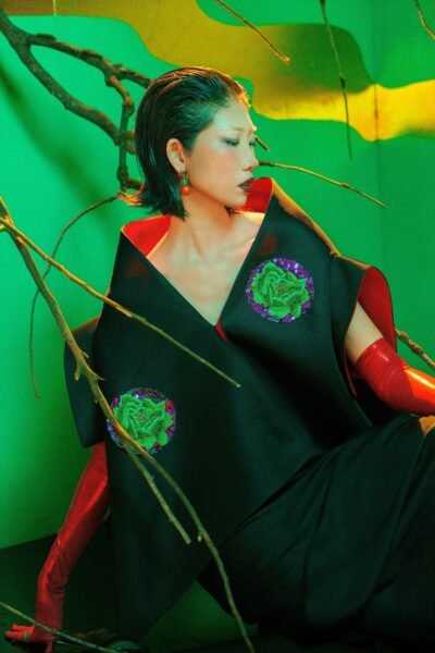 Conceptual avant-garde fashion portrait with surreal elements and vibrant colors set in Ho Chi Minh City.