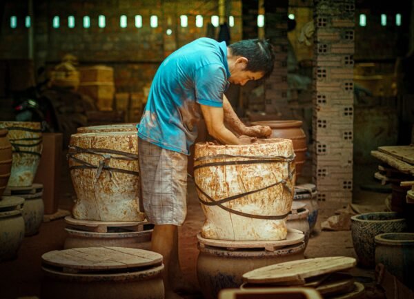 A skilled artisan crafting pottery in a traditional workshop in Ho Chi Minh City.